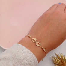 Cargar imagen en el visor de la galería, Pulsera de Infinito con Corazón, Electrocardiogama y Balines Dorados en Oro 18k
